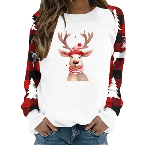 Close-up of Christmas reindeer print on white bodice with buffalo plaid sleeves and trees
