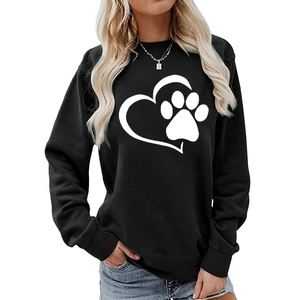 Detail of the white heart and paw print pattern on a black crewneck sweatshirt