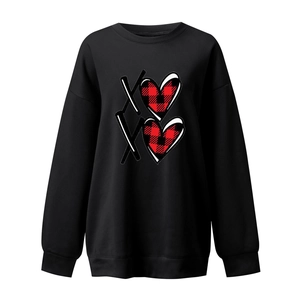 Close-up of the red buffalo plaid heart print and XO lettering on the black sweatshirt