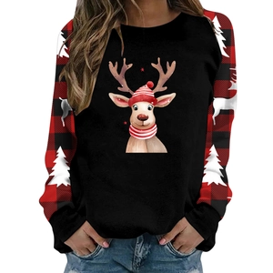 Close-up of Christmas reindeer print and red black plaid raglan sleeves on a cozy sweater