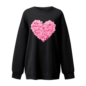 Detail of pink floral heart print on black crewneck sweatshirt with ribbed cuffs