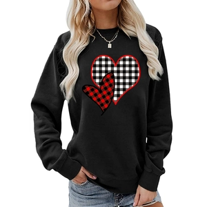 Detail view of heart-shaped patchwork patterns with red and black plaid on black sweatshirt