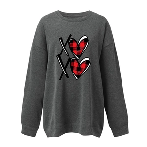 Close-up of the heart and XO print detail on this loose long sleeve grey sweatshirt
