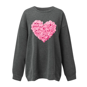 Macro detail of the pink rose petal texture inside the heart print on charcoal sweatshirt
