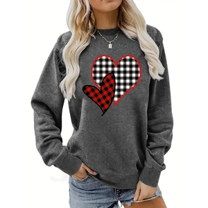 Detail of buffalo plaid heart prints on gray crewneck sweatshirt with ribbed cuffs