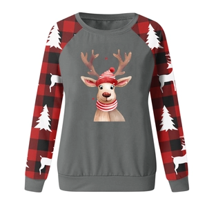 Close-up of Christmas sweatshirt with deer print and red black plaid raglan sleeves