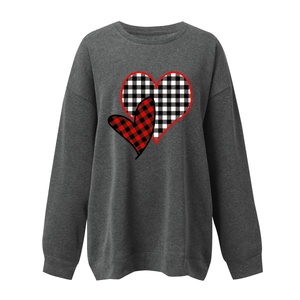 Detail of buffalo plaid heart prints on dark grey crewneck sweatshirt for women