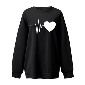 Detail of ribbed cuffs and hem on black oversized heart print sweatshirt
