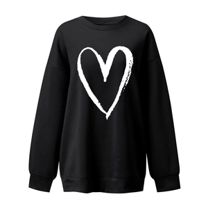 Detailed view of women's black heart print sweatshirt with ribbed cuffs and crewneck
