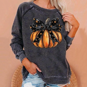 Detail of Halloween pumpkin print on dark grey long sleeve sweatshirt for women