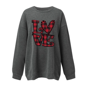 Detail of loose fit grey sweatshirt featuring heart buffalo plaid LOVE graphic print