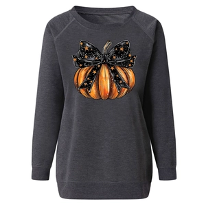 Detail of Halloween pumpkin print and black bow on grey raglan sleeve sweatshirt