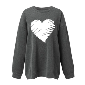 Detailed view of white heart graphic print on dark gray loose fit sweatshirt fabric