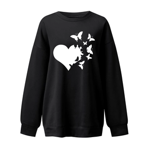 Detail of white butterfly heart print on a black crewneck sweatshirt for women