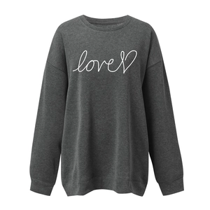 Close-up of ribbed cuffs and love heart print on charcoal oversized long sleeve sweatshirt