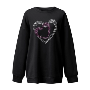 Detail of interlocking hearts in pink and white studs on a black crewneck sweatshirt