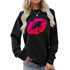 Close-up of the vibrant hot pink lip print on this black long-sleeve crewneck sweatshirt