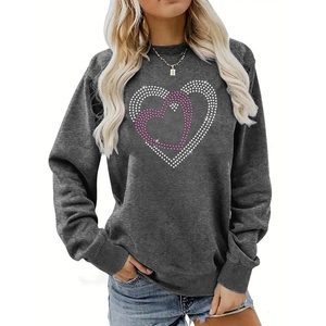 Detail of rhinestone heart patterns on a dark gray crewneck sweatshirt for women
