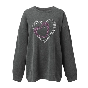 Detail of grey crewneck sweatshirt with sparkling rhinestone heart design on chest