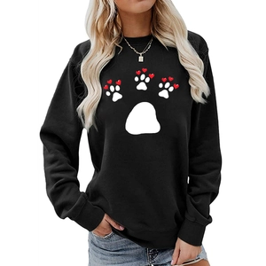 Close-up of black sweatshirt featuring a white paw print design with red hearts