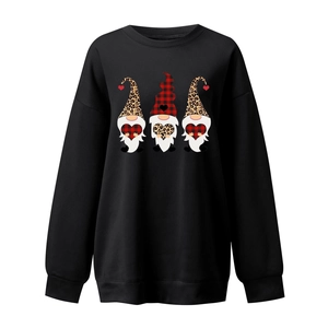 Detail of three gnomes with leopard and plaid hearts on a black crewneck sweatshirt