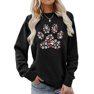 Close-up of heart and paw print pattern on black long sleeve crewneck sweatshirt