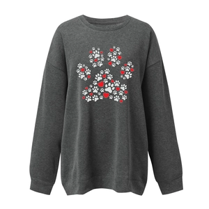 Detail view of the heart and paw print pattern on this grey long sleeve sweatshirt