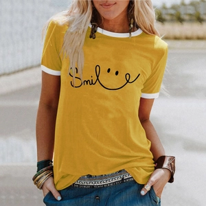 Close-up of yellow t-shirt with Smile print, white contrast neckline and sleeve detail