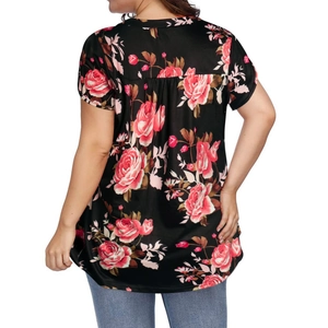 Detail view of the floral print pattern and pleated back seam on a black short sleeve top