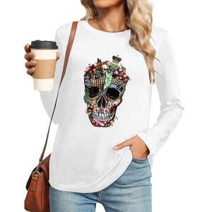 Close-up of elegant white long sleeve T-shirt with colorful artistic skull print details