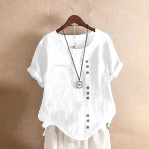 Detail showing white cotton-linen blouse with decorative wooden buttons and pocket