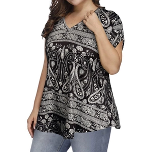 Detail of V-neck plus size top featuring intricate black and white paisley and floral print