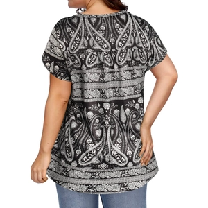 Back view of women's loose V-neck top featuring intricate black and white paisley patterns