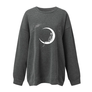 Close-up of skeleton and crescent moon print on charcoal gray oversized sweatshirt