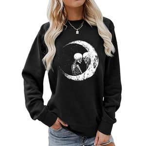 Close-up of Halloween sweatshirt showing moon and skeleton print on black cotton fabric