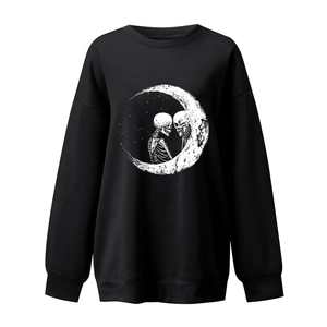 Close-up of gothic moon and skull graphic print on black crewneck sweatshirt details