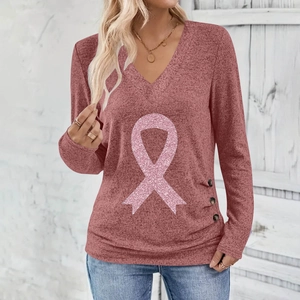 Detail view of pink ribbon print and buttons on women's V-neck long sleeve top