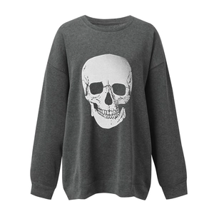 Detail of grey crewneck sweatshirt featuring a large white skull print and drop shoulders