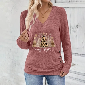 Close-up of Christmas tree print and button detail on dark red V-neck long sleeve top