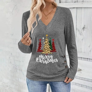 Detail of Christmas tree prints and decorative side buttons on dark grey V-neck top