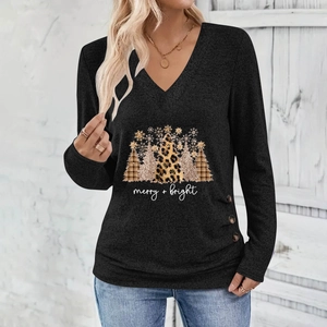 Detail of Christmas tree print and side buttons on a black long-sleeve V-neck top