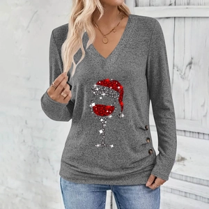 Detail of Christmas wine glass print and side decorative buttons on V-neck long sleeve top