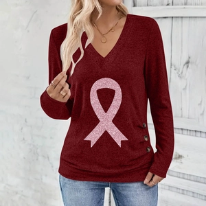 Detail of V-neck long sleeve top in wine red with pink ribbon sequin and side buttons