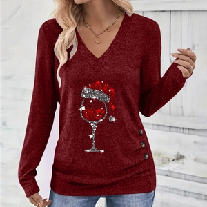 Detail of elegant V-neck wine red top with Christmas wine glass print and button accents