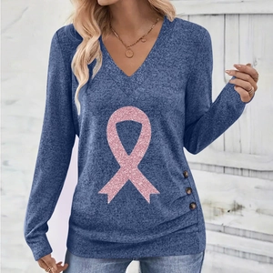 Detail of V-neck top showing pink glitter ribbon print and decorative side buttons