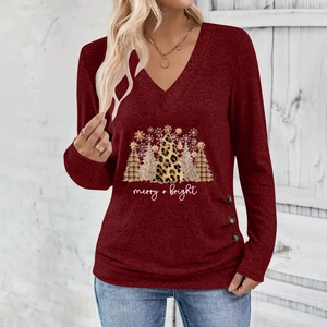 Close-up of leopard Christmas tree and merry plus bright lettering on dark red V-neck top