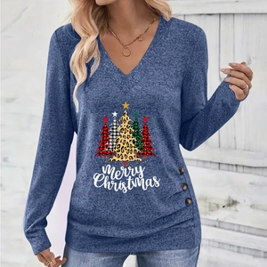 Detail of blue V-neck Christmas shirt featuring festive tree prints and side button accents