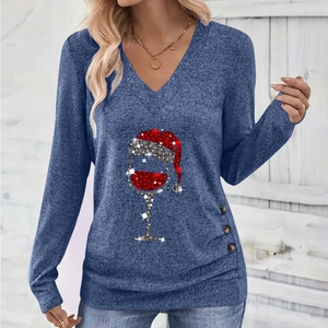 Detail of Christmas wine glass glitter print and decorative wood buttons on V-neck top