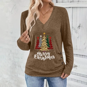 Detail of Christmas tree print and decorative buttons on a brown V-neck long sleeve shirt