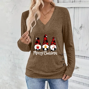 Detail of V-neck top showing Santa gnomes print and decorative buttons on brown fabric